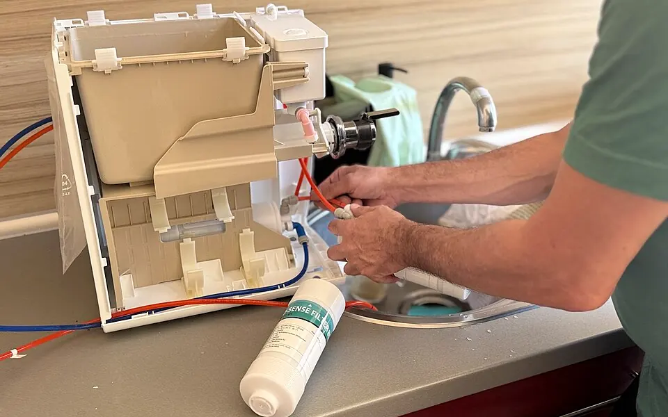Technician repairing the internal components of a kitchen appliance
