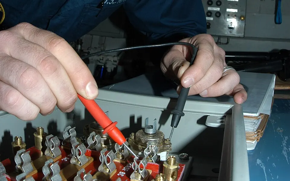 Electrician fault-finding at an electrical distribution panel