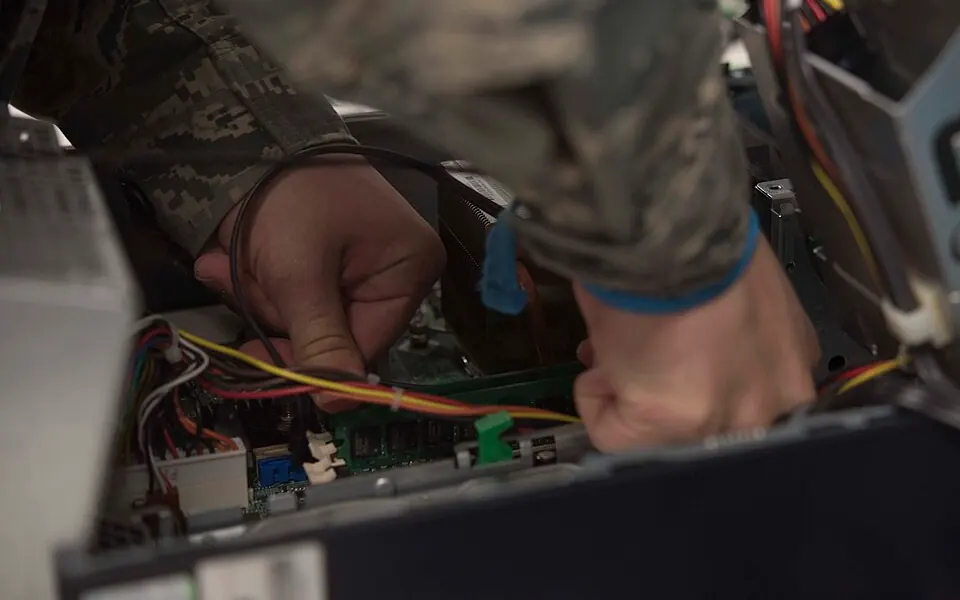 Technician replacing components inside a computer